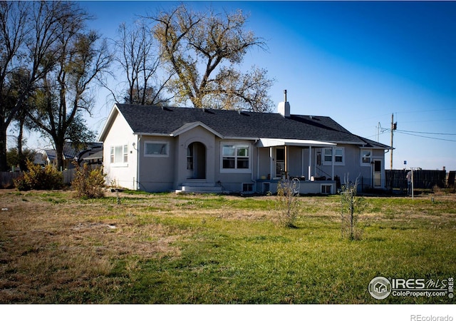 317 Second St, Roggen, CO 80652 - view of front of property with covered porch, roof with shingles, stucco siding, a front yard, and a chimney
