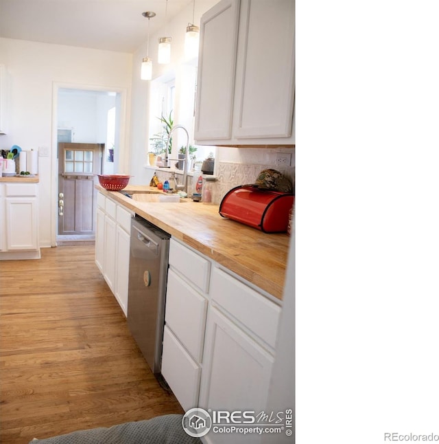 kitchen with dishwasher, light wood-type flooring, wood counters, white cabinetry, and pendant lighting