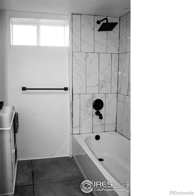 bathroom featuring vanity, tiled shower / bath combo, and tile patterned floors