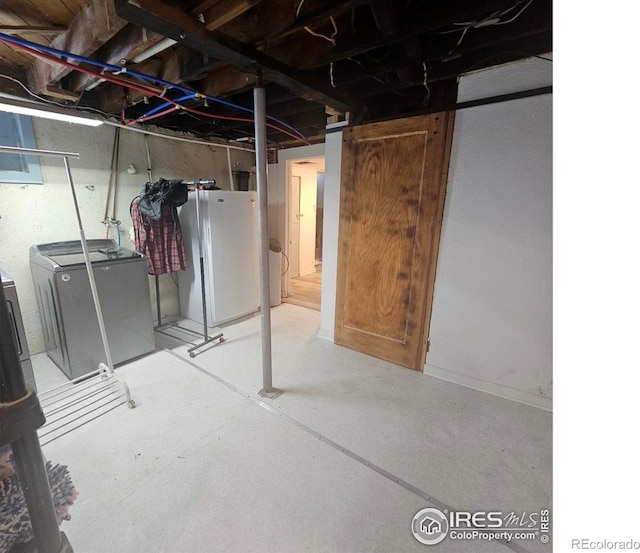 317 Second St, Roggen, CO 80652 - unfinished below grade area featuring washing machine and dryer and freestanding refrigerator
