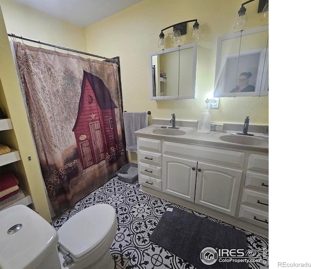 317 Second St, Roggen, CO 80652 - bathroom featuring toilet, a shower with curtain, double vanity, and a sink