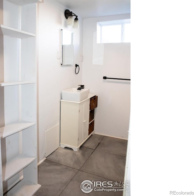 317 Second St, Roggen, CO 80652 - bathroom with vanity, concrete floors, and electric panel
