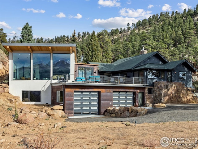 modern home featuring a balcony and a garage