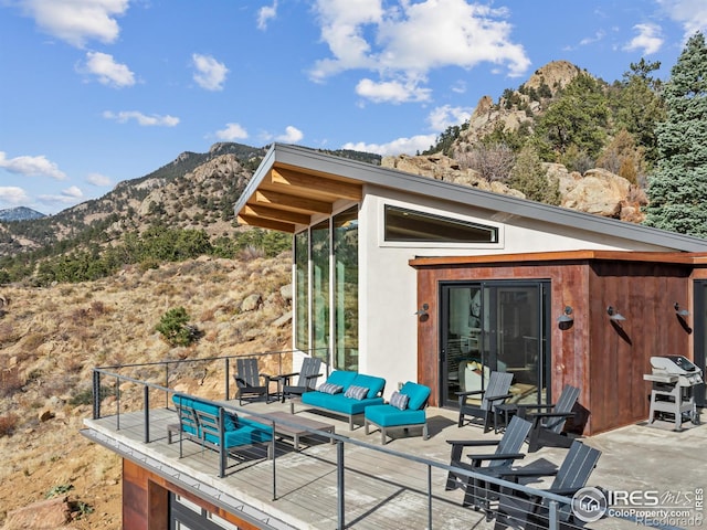 view of patio / terrace with a mountain view and an outdoor living space