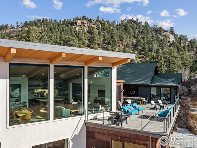 exterior space featuring a wooden deck and an outdoor fire pit