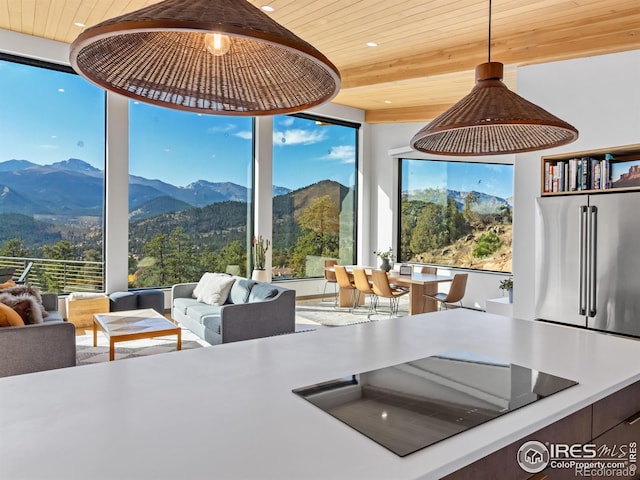 kitchen with wood ceiling, a mountain view, and a wealth of natural light