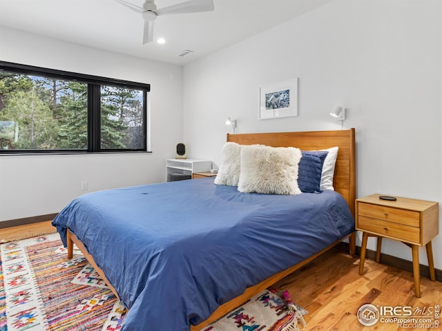 bedroom with ceiling fan and hardwood / wood-style floors