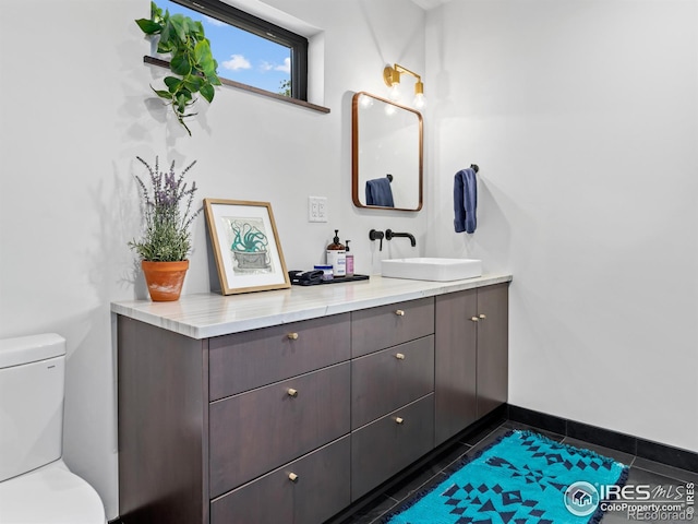 bathroom featuring vanity, toilet, and tile patterned flooring