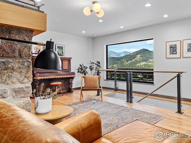 living room with an inviting chandelier and hardwood / wood-style flooring