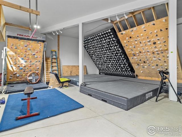 workout room featuring concrete floors