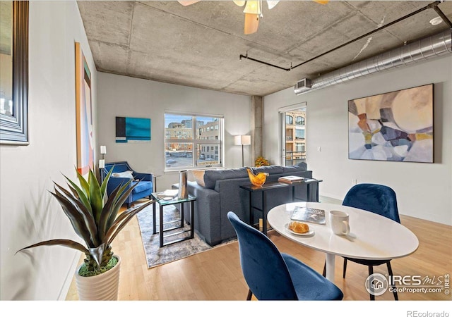 dining space with wood-type flooring and ceiling fan