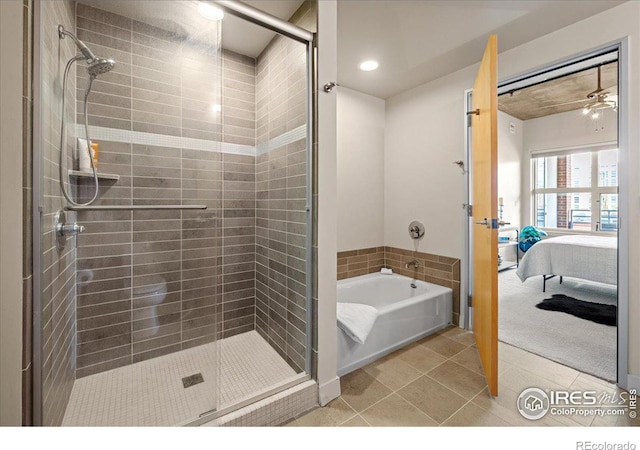 bathroom featuring shower with separate bathtub and tile patterned flooring