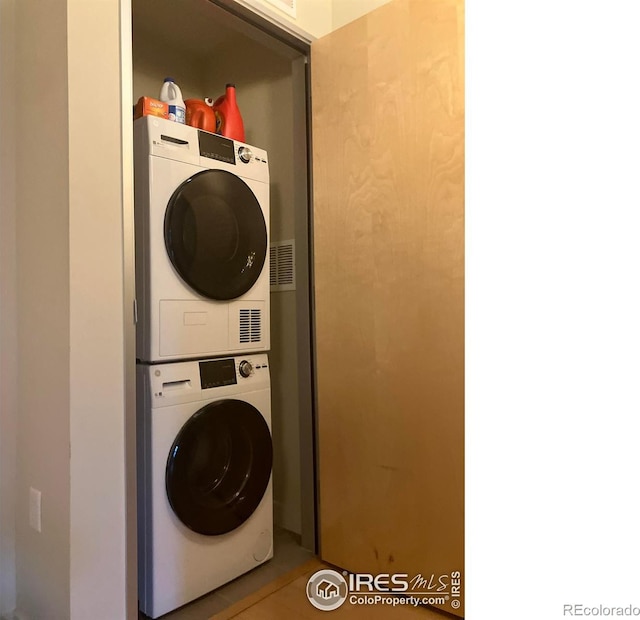 laundry room with stacked washer and clothes dryer