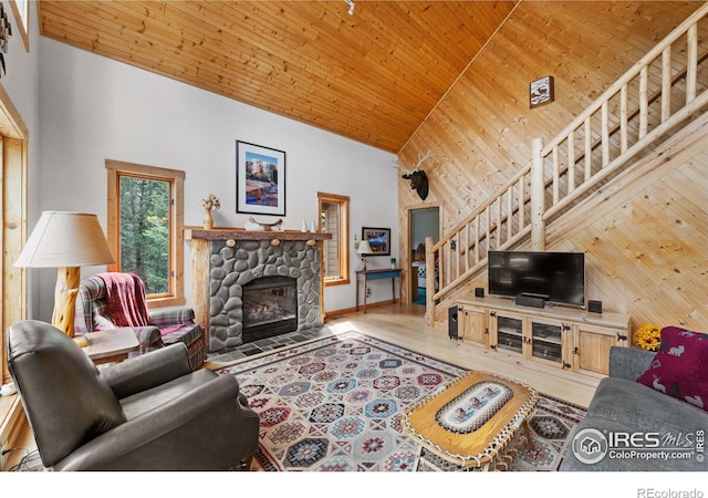 743 Hickory Dr, Lyons, CO 80540 - living area featuring stairs, high vaulted ceiling, wood ceiling, a fireplace, and wood finished floors