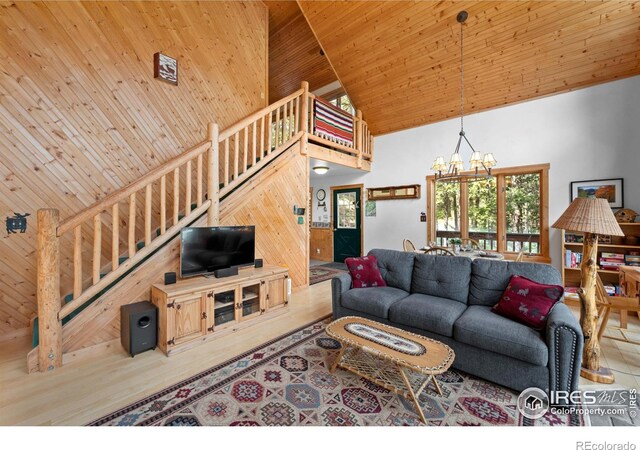 743 Hickory Dr, Lyons, CO 80540 - living area with high vaulted ceiling, stairs, wooden ceiling, and a chandelier