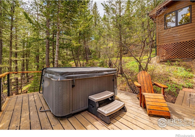 743 Hickory Dr, Lyons, CO 80540 - wooden terrace featuring a hot tub and a forest view