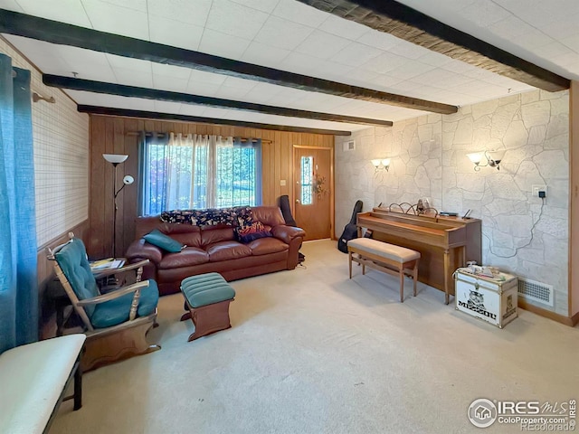 carpeted living room featuring visible vents and beam ceiling