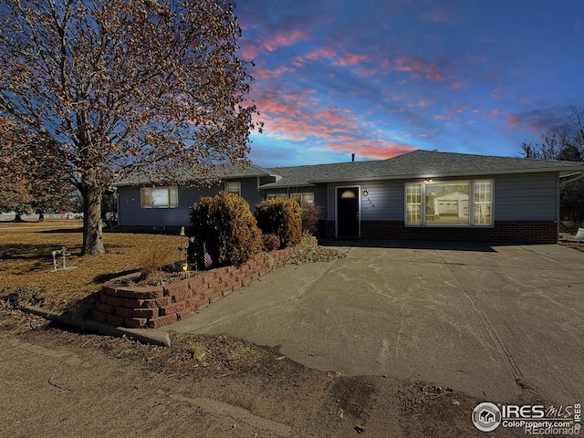 single story home with brick siding and driveway