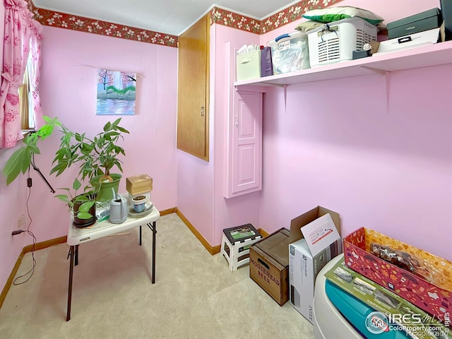 interior space featuring light colored carpet and baseboards