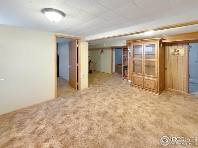 finished basement with light carpet and baseboards