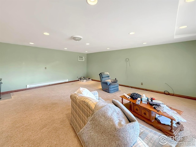 living area with a baseboard heating unit, recessed lighting, and baseboards