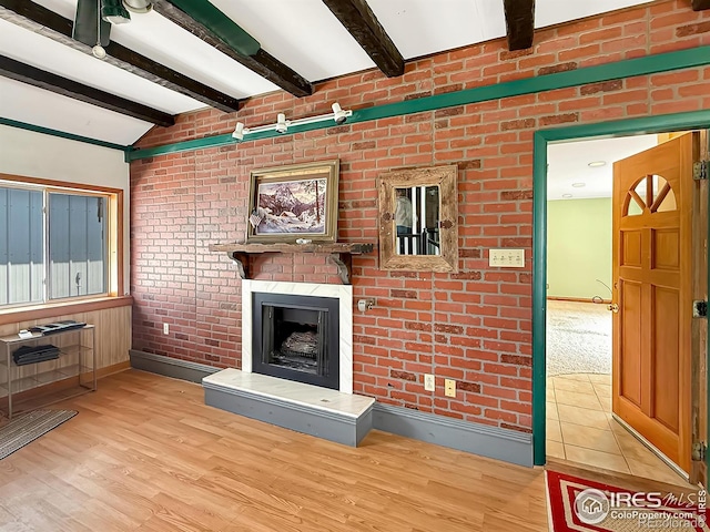 654 W Strohm St, Haxtun, CO 80731 - unfurnished living room featuring wood finished floors and a large fireplace
