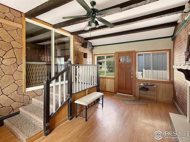 654 W Strohm St, Haxtun, CO 80731 - entrance foyer with wood finished floors, ceiling fan, beam ceiling, stairway, and wood walls
