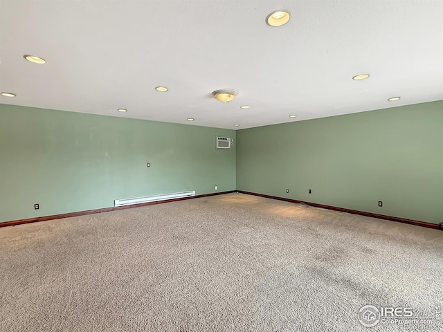 654 W Strohm St, Haxtun, CO 80731 - spare room with a baseboard heating unit, carpet flooring, recessed lighting, and baseboards