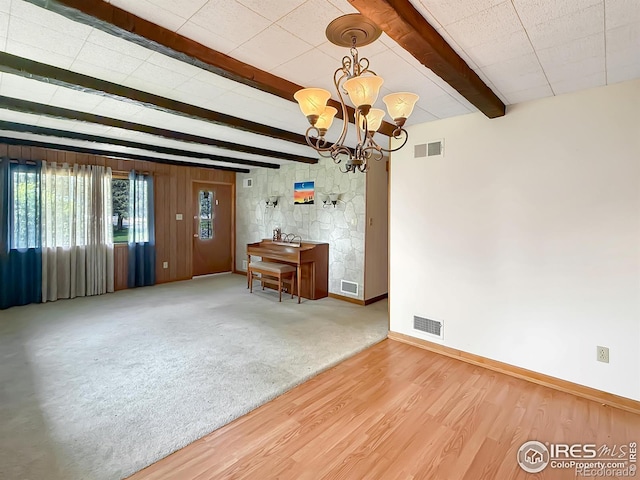 654 W Strohm St, Haxtun, CO 80731 - unfurnished room with a chandelier, beamed ceiling, and wood finished floors