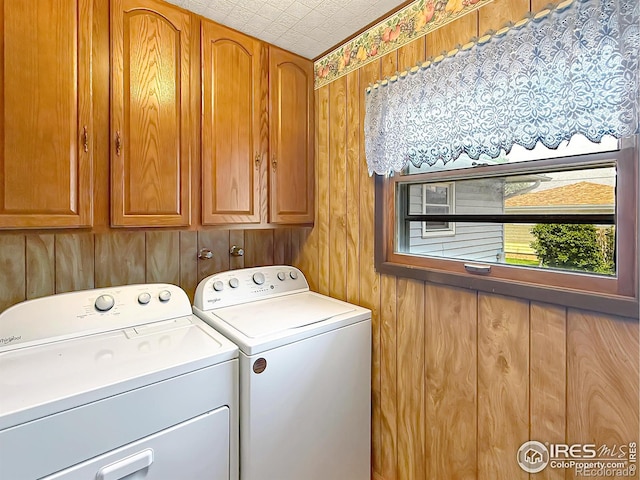 654 W Strohm St, Haxtun, CO 80731 - laundry area with cabinet space, washing machine and dryer, and wood walls