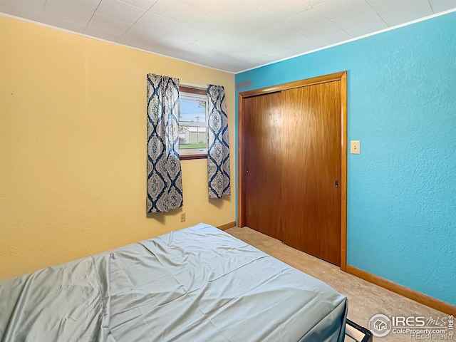 654 W Strohm St, Haxtun, CO 80731 - bedroom with a textured wall, carpet, and a closet