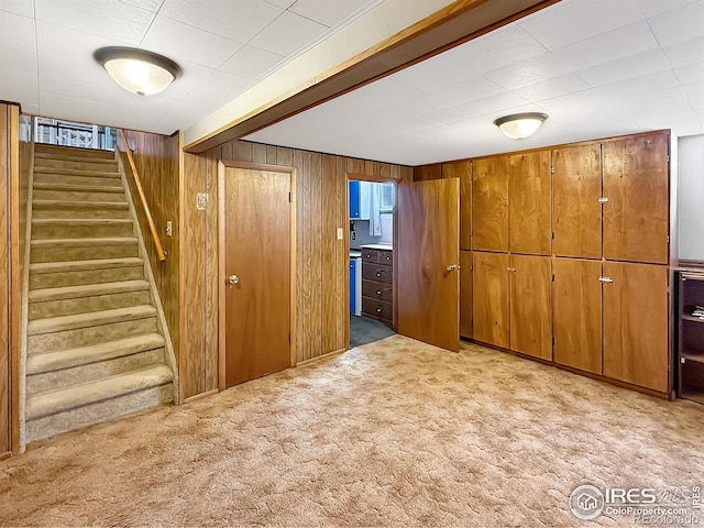 654 W Strohm St, Haxtun, CO 80731 - basement featuring light colored carpet, stairs, and wood walls