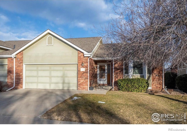 ranch-style home featuring a garage, a front yard, concrete driveway, and brick siding