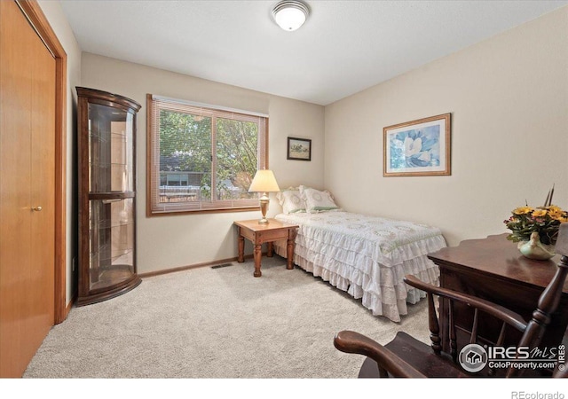 carpeted bedroom featuring visible vents and baseboards