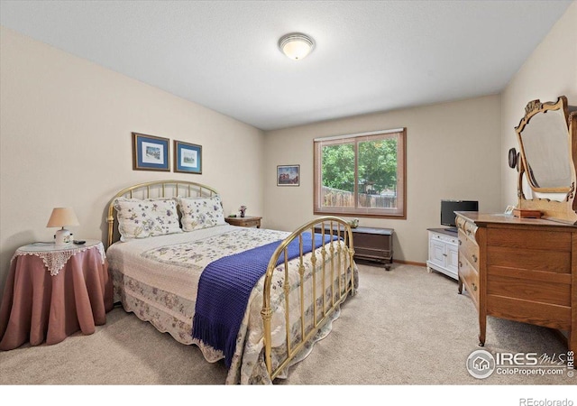 carpeted bedroom with baseboards