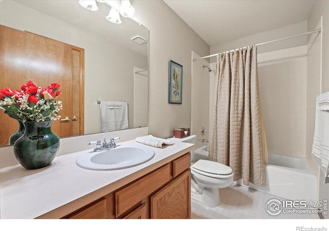 full bath with vanity, shower / bath combo with shower curtain, toilet, and tile patterned floors