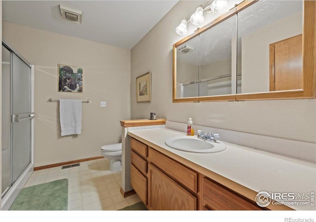 full bathroom with vanity, a shower stall, and visible vents