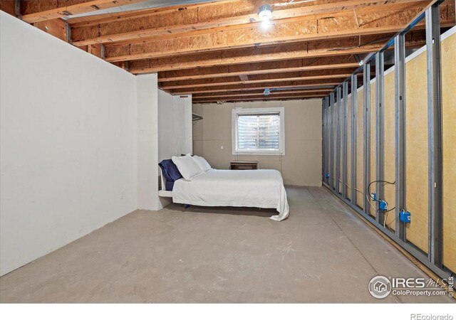 unfurnished bedroom featuring concrete flooring