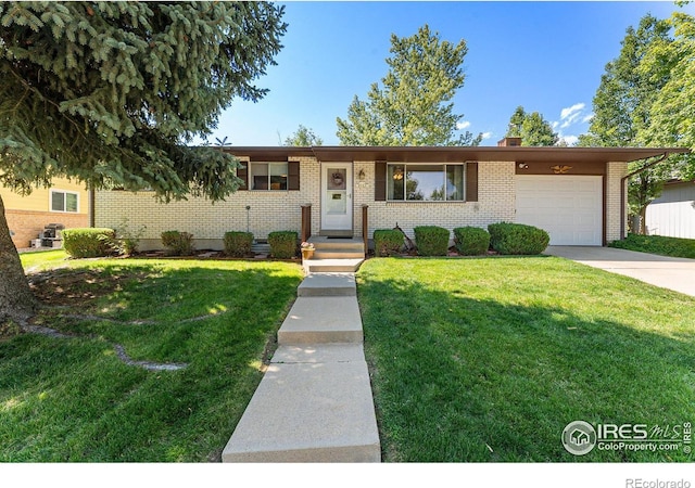 view of front of house with a garage and a front lawn