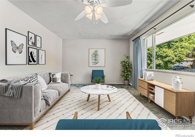 carpeted living room with ceiling fan