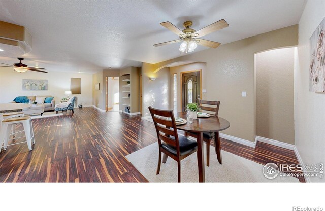 dining space featuring hardwood / wood-style floors, a textured ceiling, and ceiling fan