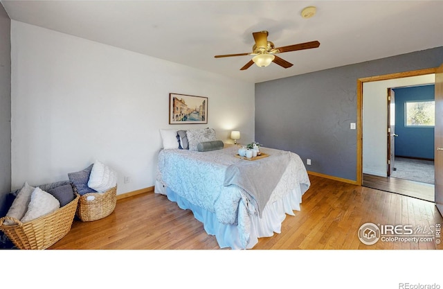 bedroom with hardwood / wood-style flooring and ceiling fan