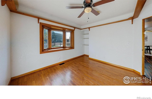 empty room featuring hardwood / wood-style flooring and ceiling fan