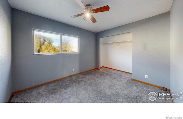 unfurnished bedroom with a closet, carpet, and ceiling fan