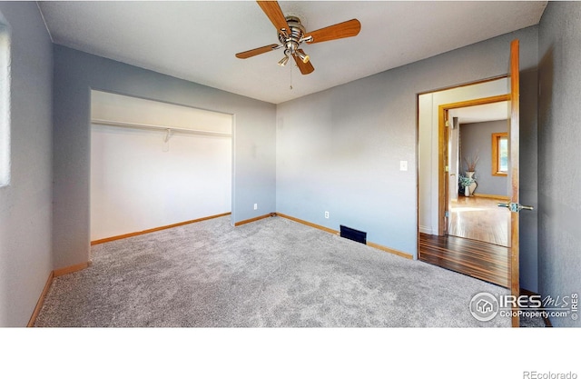 unfurnished bedroom featuring a closet, carpet flooring, and ceiling fan