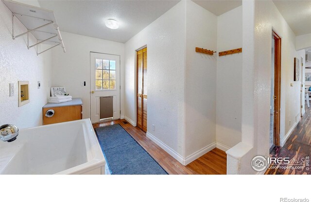 laundry area featuring hookup for an electric dryer, hardwood / wood-style floors, hookup for a washing machine, and sink