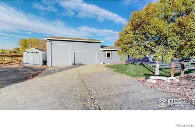 view of front of house featuring a front lawn and an outbuilding