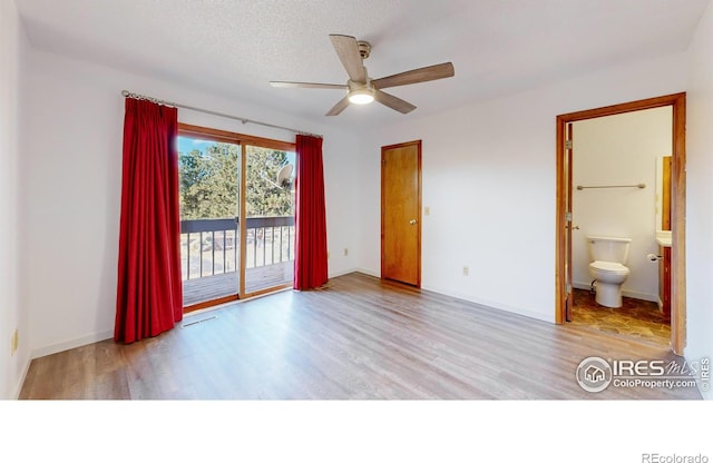 unfurnished bedroom featuring access to exterior, a textured ceiling, connected bathroom, ceiling fan, and light wood-type flooring