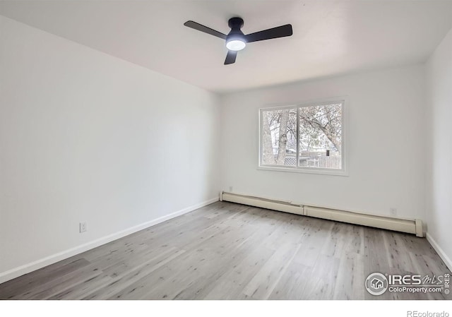 empty room featuring a baseboard heating unit, light hardwood / wood-style flooring, and ceiling fan