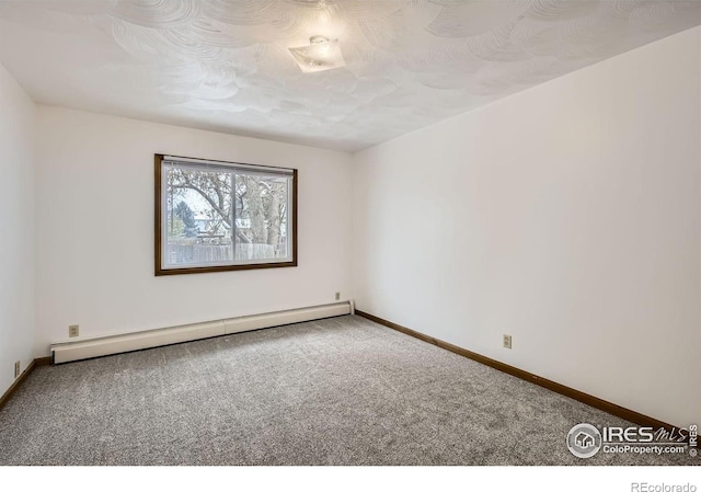 spare room featuring carpet, a textured ceiling, and a baseboard heating unit